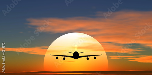 airplane flying against the background of sunset