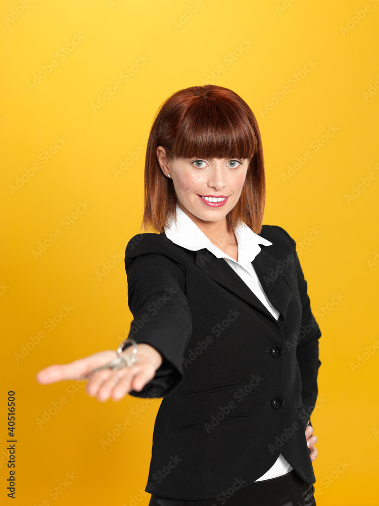 attractive, young businesswoman holding house keys attractive, young businesswoman holding house keys