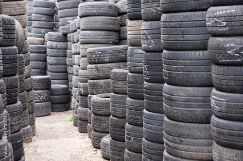 Stacks of car tyres on concrete