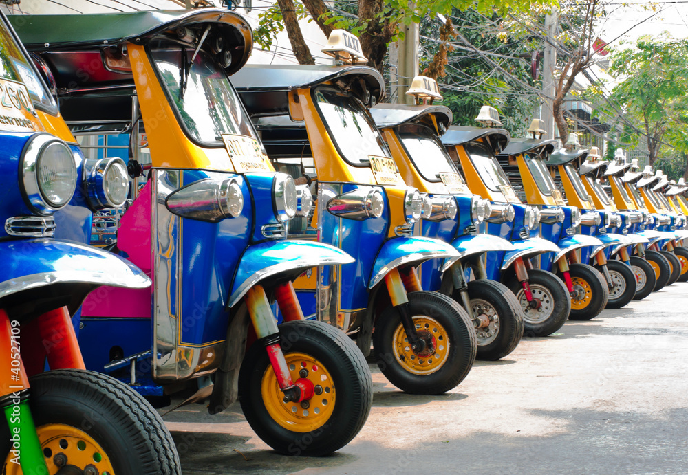 Tuk tuks taxi lined up in Bangkok, Thailand - obrazy, fototapety, plakaty 