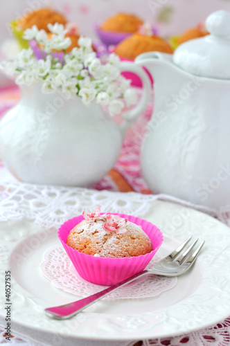 Cupcake with teapot and jug at background