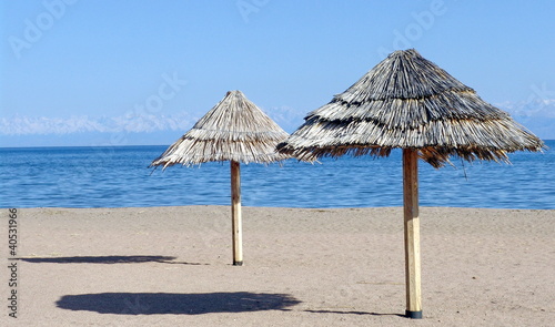 Two beach umbrellas on the sand © tracingtea