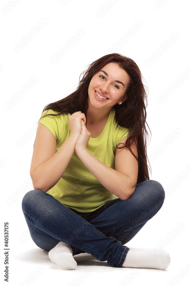A college girl sitting on the floor, isolated on white A college girl sitting on the floor, isolated on white