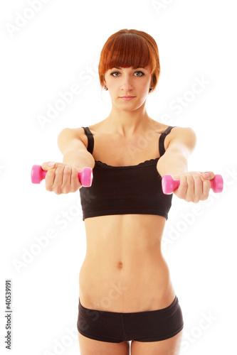 A woman with dumbbells in her hands on white