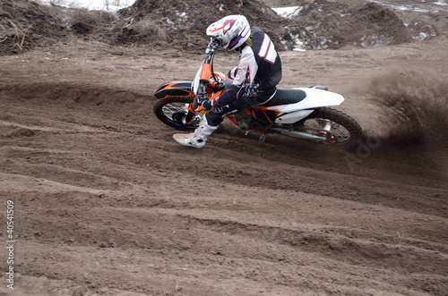 Motocross rider veering point-blank of sand with