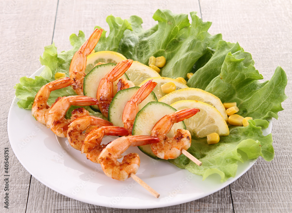 grilled shrimp on stick with salad