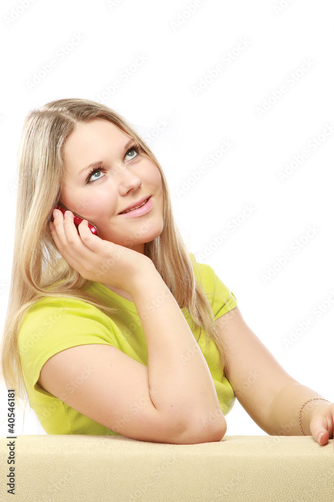 Obraz premium A young woman sitting on the chair with a mobile phone