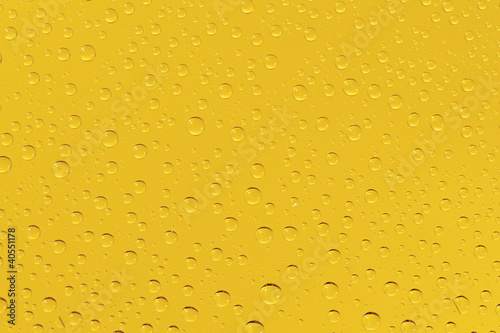 Many water drops on the yellow background