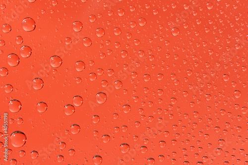 Many water drops on the red background