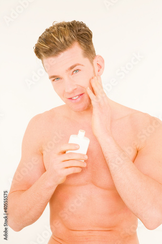 Photography Young man applying aftershave