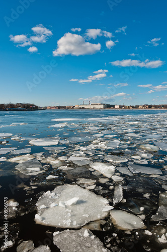 Broken ice pieces floating on river