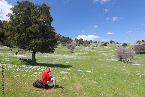 Red dressed hiker resting