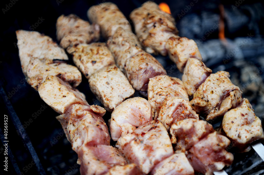 Juicy slices of meat with spices cooking on fire Juicy slices of meat with spices cooking on fire