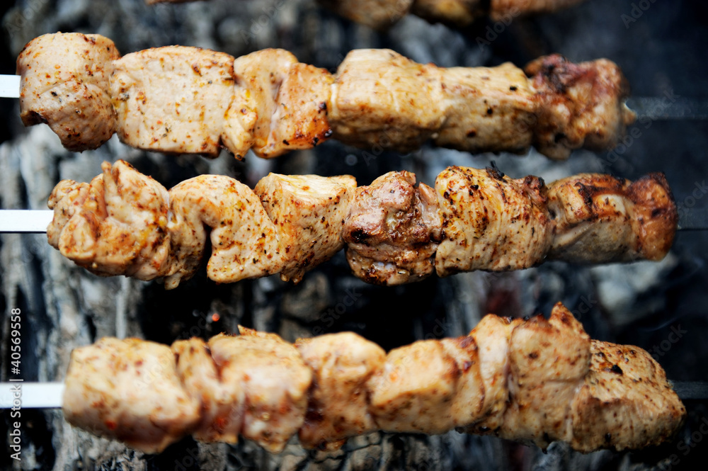 Juicy slices of meat with spices cooking on fire Juicy slices of meat with spices cooking on fire