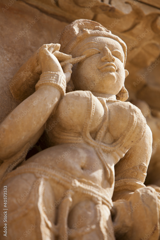 Khajuraho carving of a woman applying makeup Khajuraho carving of a woman applying makeup
