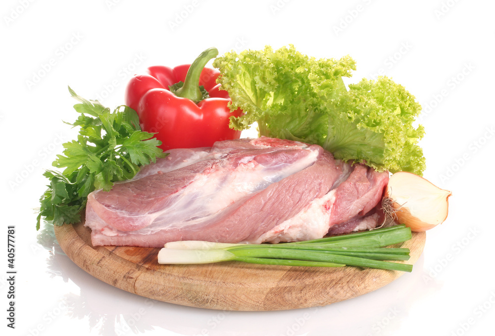 Raw meat and vegetables on a wooden board isolated on whitе