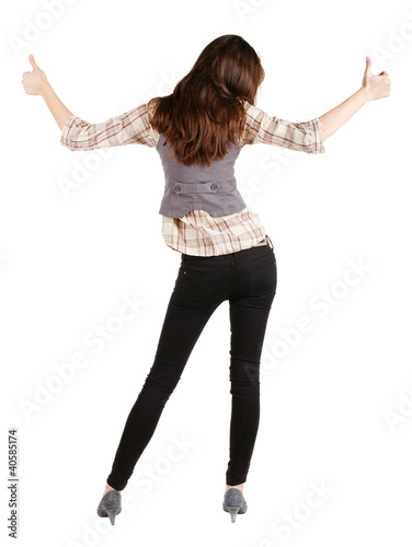 Back view of of beautiful brunette woman in jeans