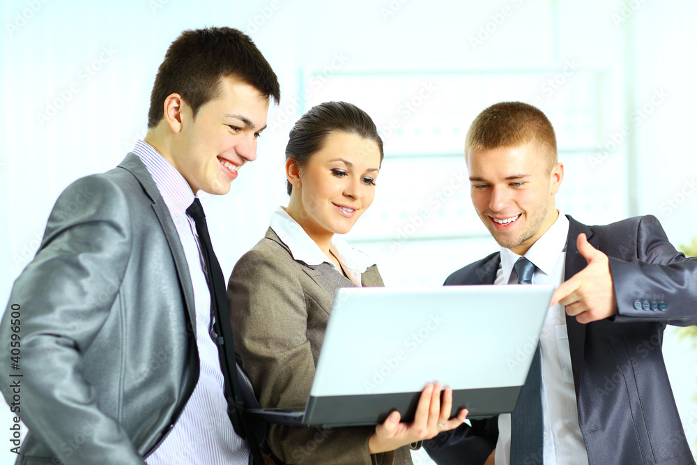 Young businesswoman with her collegues using laptop Young businesswoman with her collegues using laptop