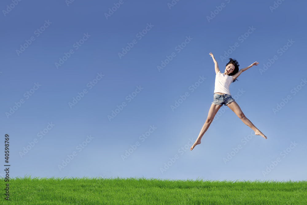 Excited woman jumping over blue sky Excited woman jumping over blue sky