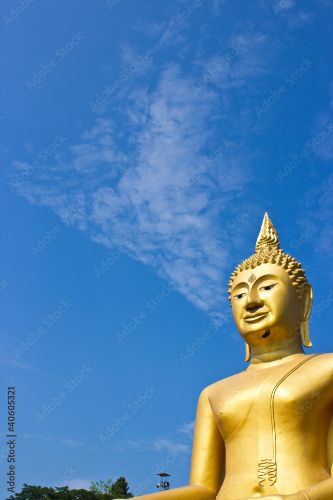 Golden Statue of Buddha in Thailand and blue sky