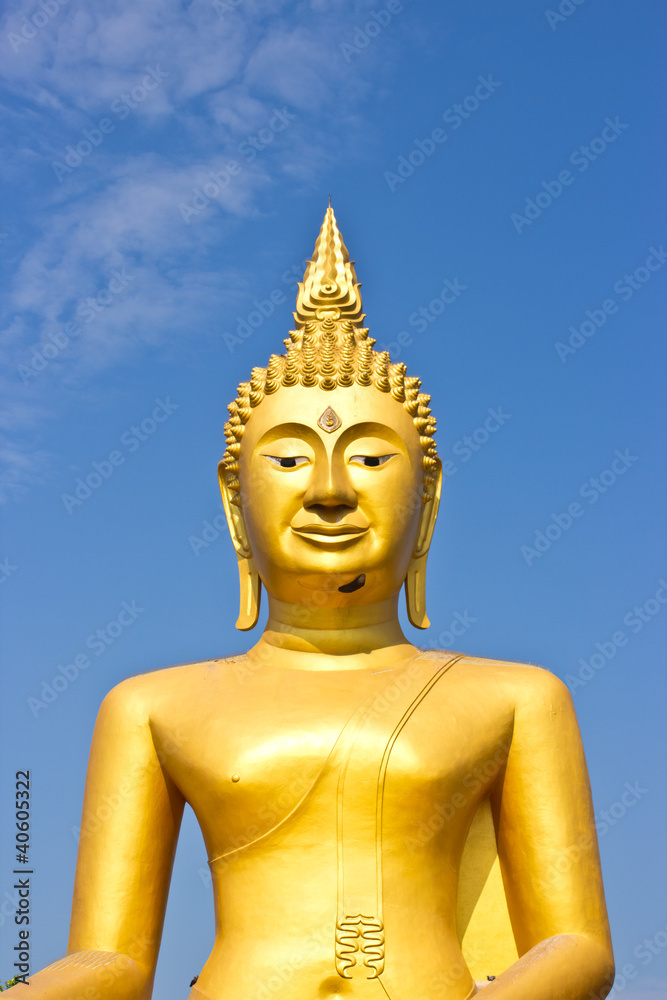 Golden Statue of Buddha in Thailand and blue sky