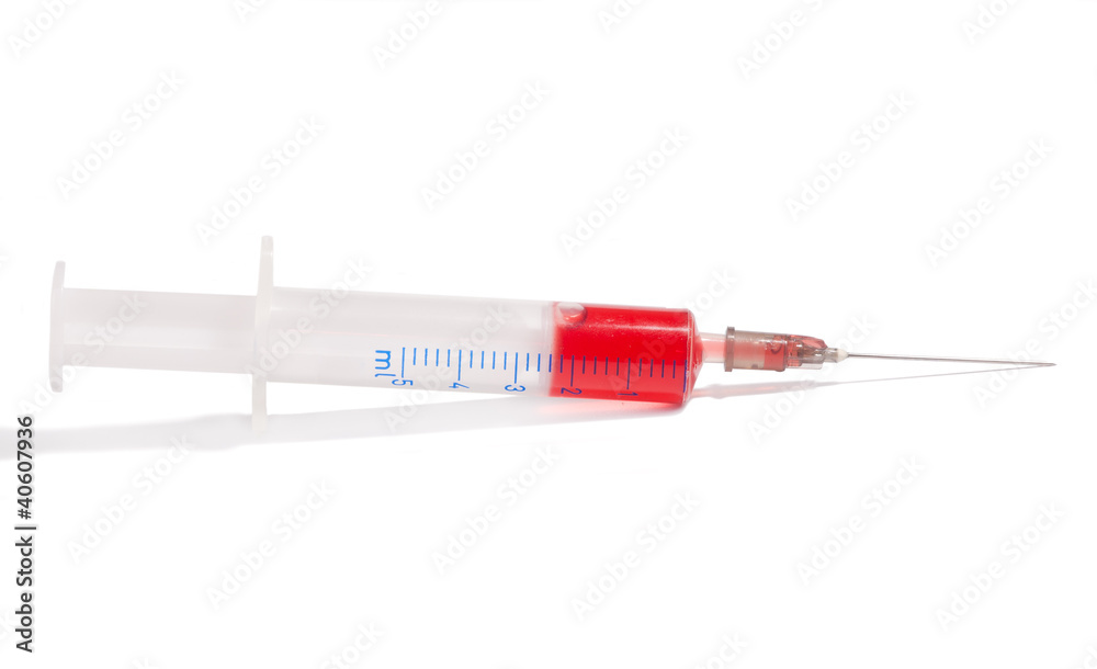 Fototapeta premium syringe with red medication on white