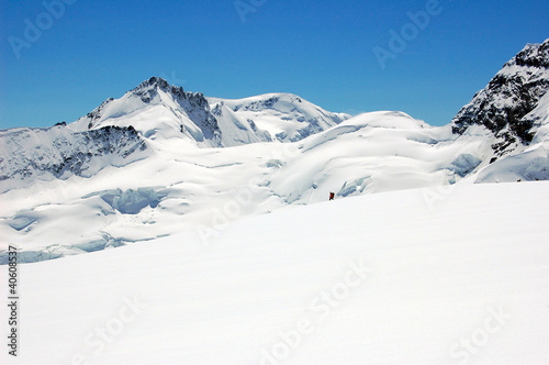 Alpinist passing glacier of Jungfrau
