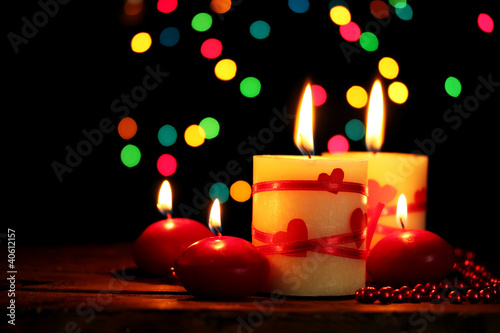 Beautiful candles on wooden table on bright background