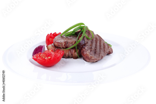beef steaks strips on white plate