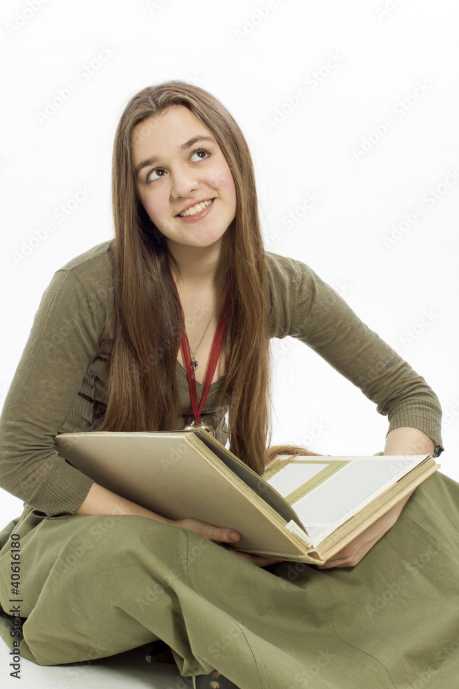 Beautiful the young brunette reading a book while sitting Beautiful the young brunette reading a book while sitting