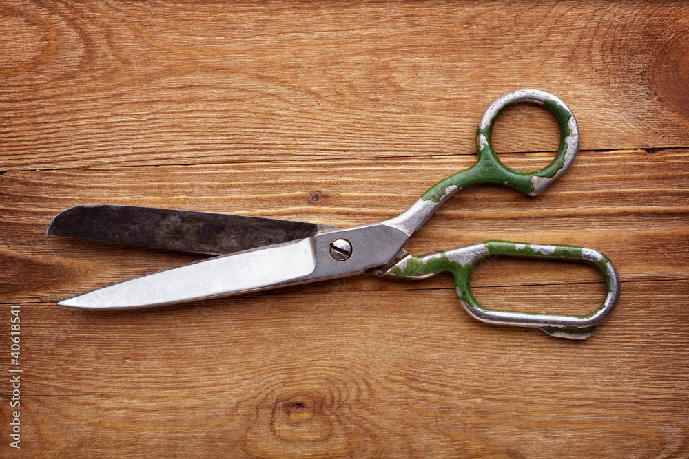 old scissors on wood background old scissors on wood background