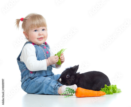 Funny little girl feeding a...