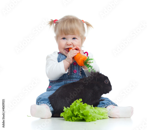 Smiling little girl eating ...