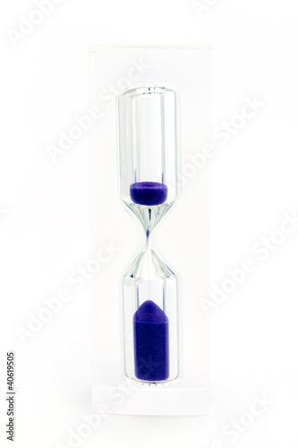 Hourglass with purple sand over white