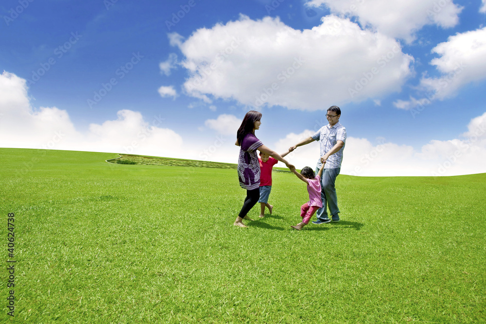 Happy Asian Family in Meadow