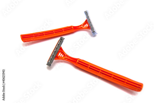 two orange razor blades on white