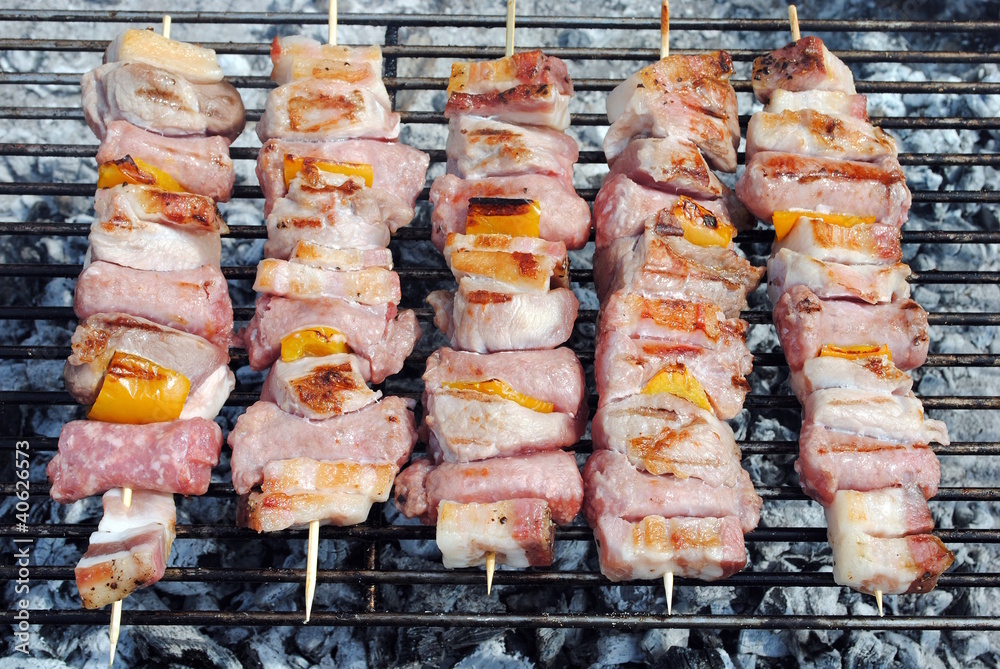 cocked pork kabobs grilled on skewers on a barbecue