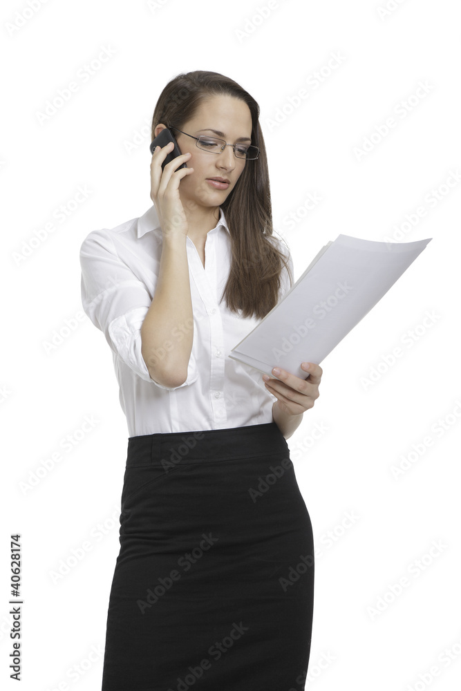 Businesswoman looking papers and on the phone Businesswoman looking papers and on the phone