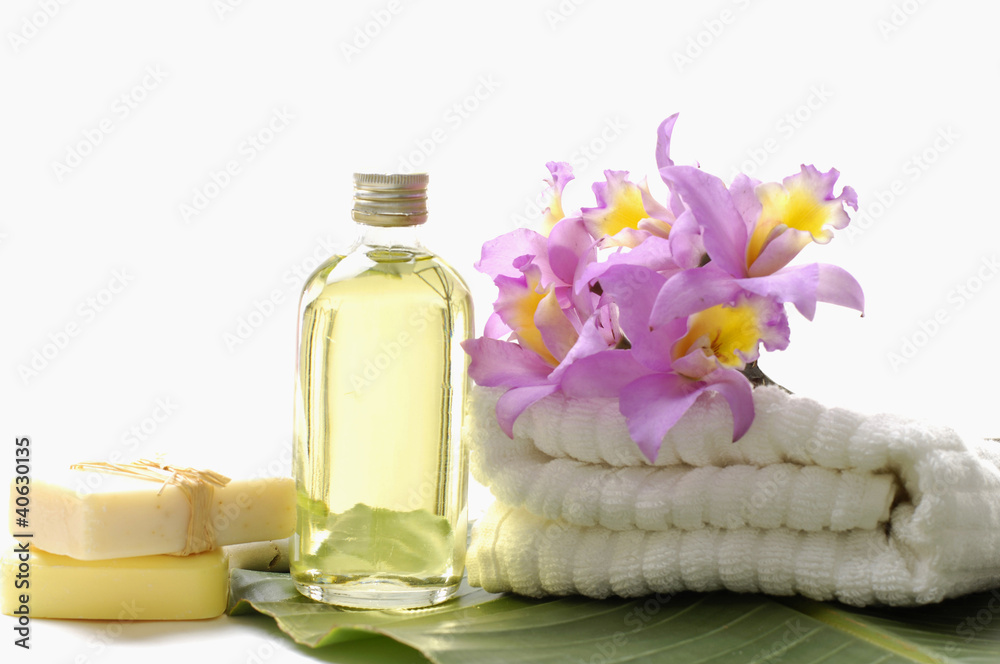 bouquet orchid on white towels with massage oil on banana leaf bouquet orchid on white towels with massage oil on banana leaf