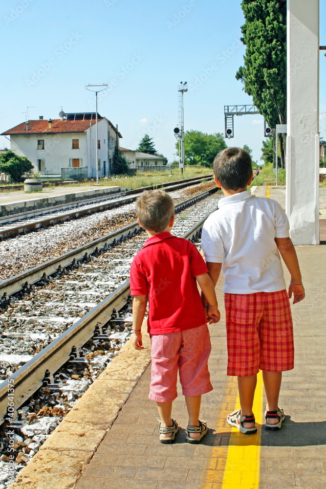 two brothers,children waiting for the train station two brothers,children waiting for the train station