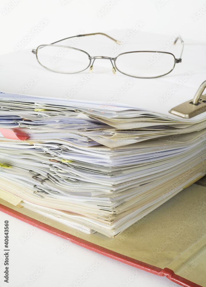 open file folder with spectacles and paper clips open file folder with spectacles and paper clips