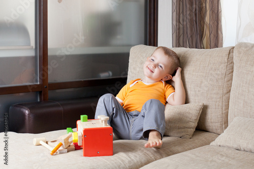 adorable boy siiting with w...