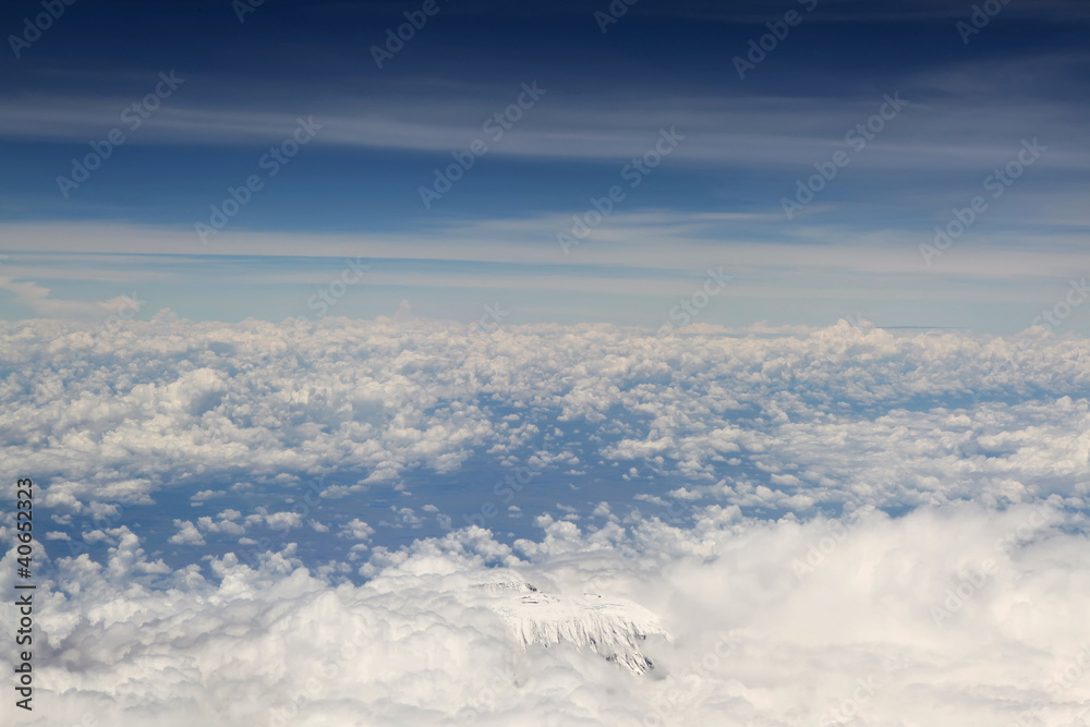 Kilimanjaro top from above, surrounded with white clouds