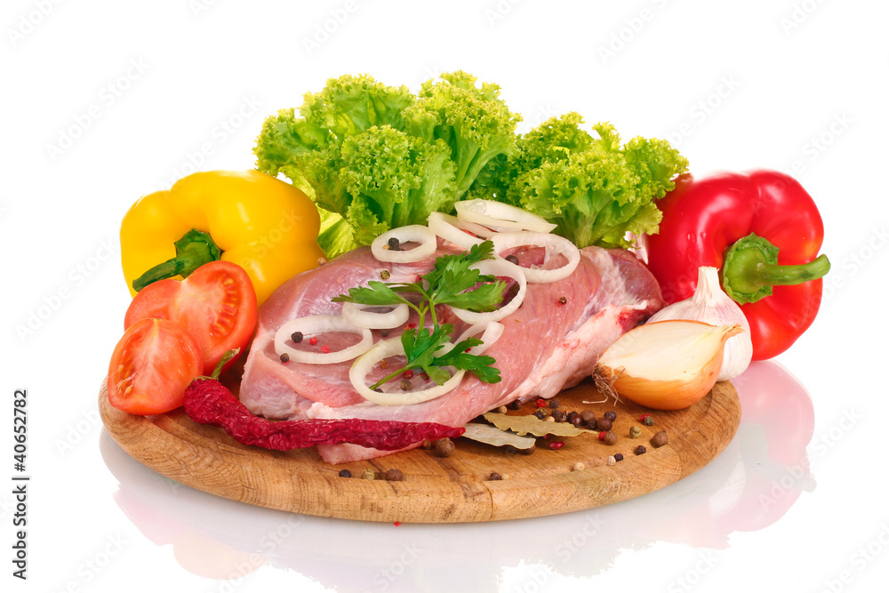 Raw meat and vegetables on a wooden board isolated on whitе Raw meat and vegetables on a wooden board isolated on whitе