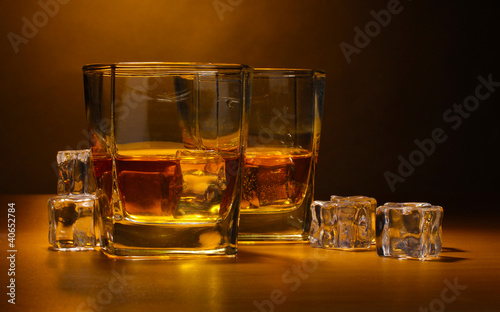 two glasses of scotch whiskey and ice