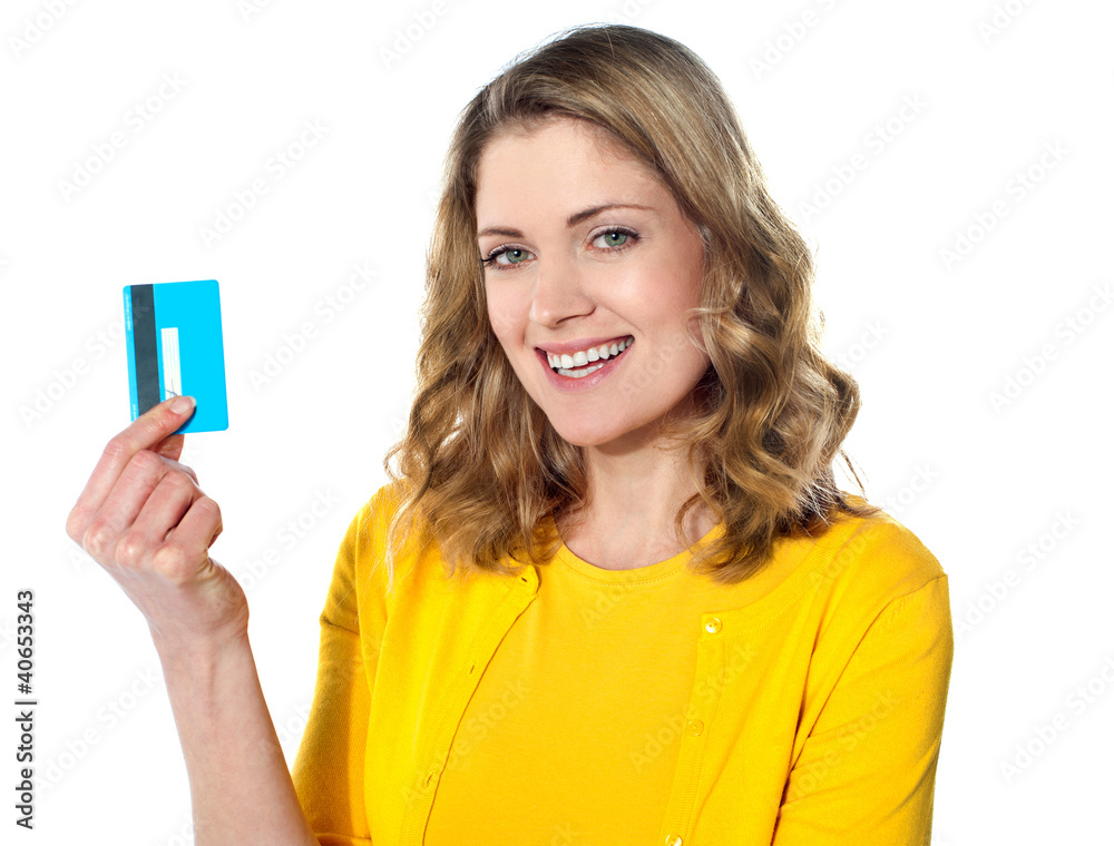 Portrait of young smiling woman holding credit card Portrait of young smiling woman holding credit card