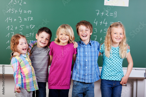 lachende schulkinder vor der tafel photo