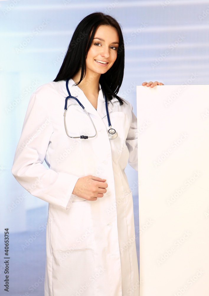 Young doctor with stethoscope and blank banner isolated Young doctor with stethoscope and blank banner isolated