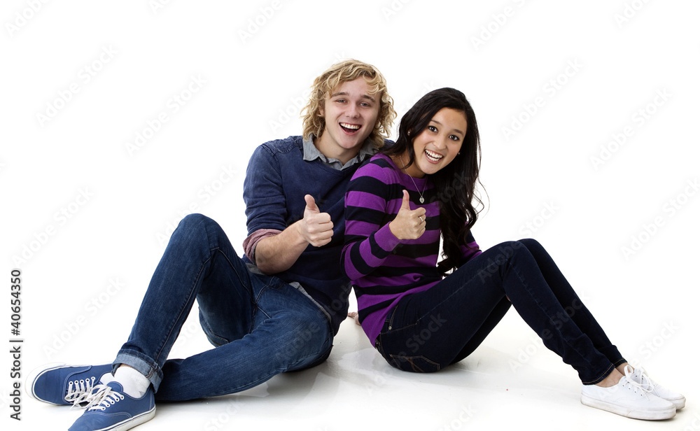 happy young man and woman giving the thumbs up sign