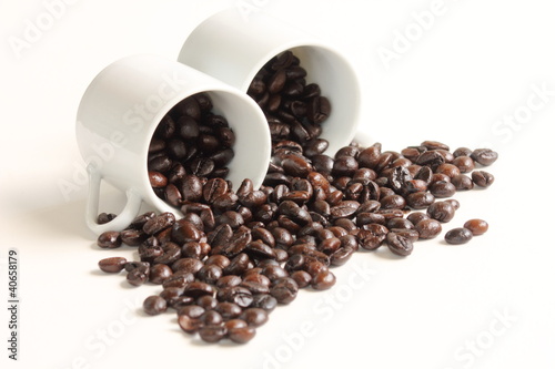 Coffee beans with a white ceramic cup
